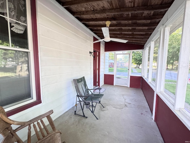 unfurnished sunroom with wooden ceiling, ceiling fan, and lofted ceiling