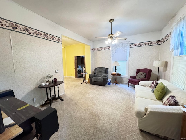 carpeted living room featuring ceiling fan