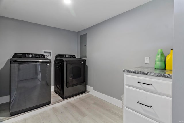 clothes washing area featuring electric panel, separate washer and dryer, and light hardwood / wood-style floors