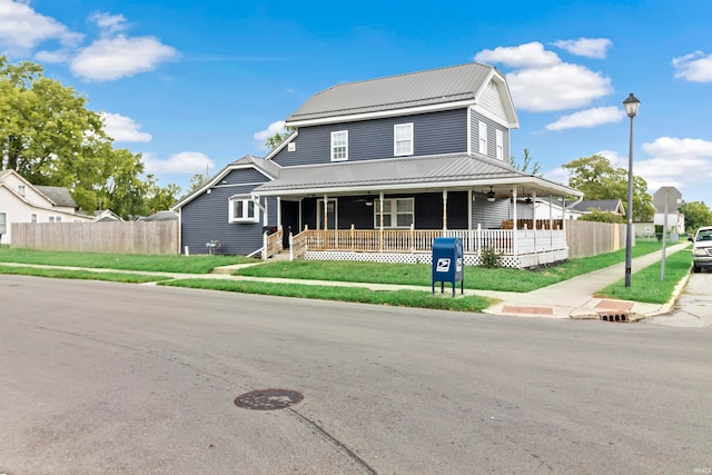 view of front facade featuring covered porch and a front lawn