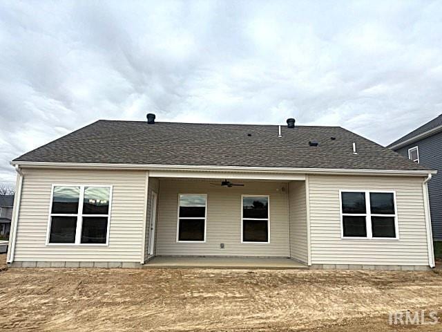 back of property with a patio, a ceiling fan, and roof with shingles