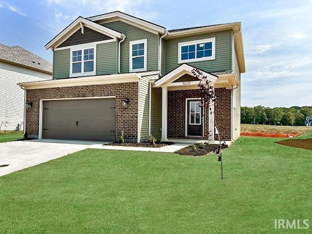 view of front of property featuring a garage and a front lawn