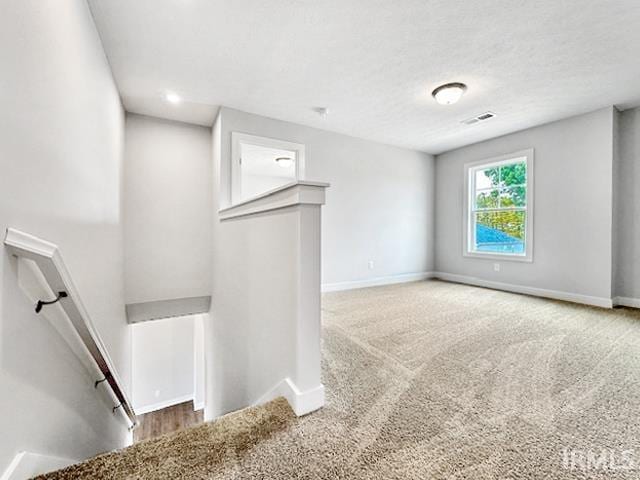 unfurnished living room with carpet flooring