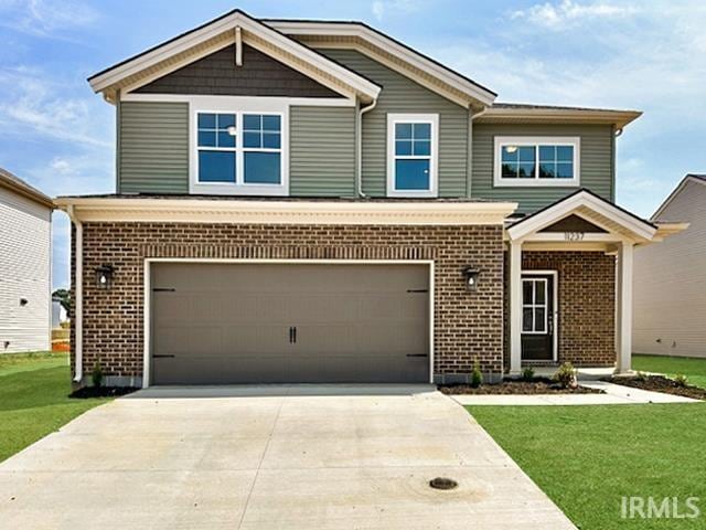 view of front of house with a front yard and a garage