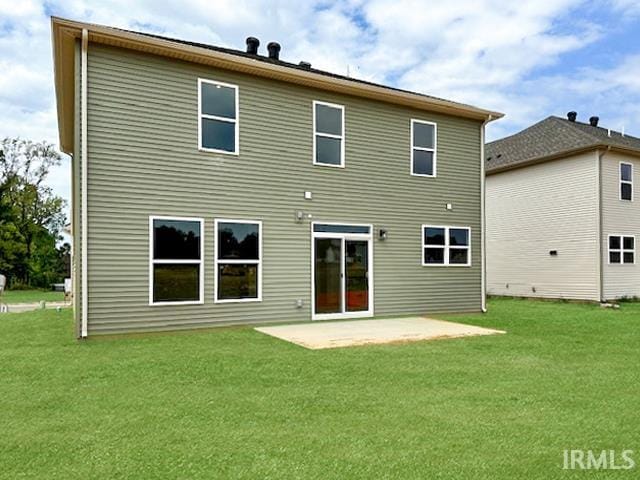 rear view of property featuring a patio and a lawn