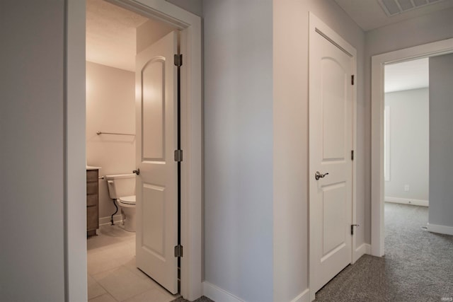 hallway featuring light colored carpet