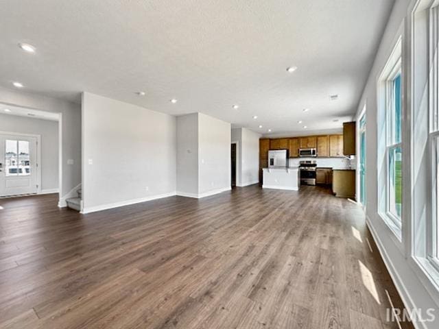 unfurnished living room with dark hardwood / wood-style flooring