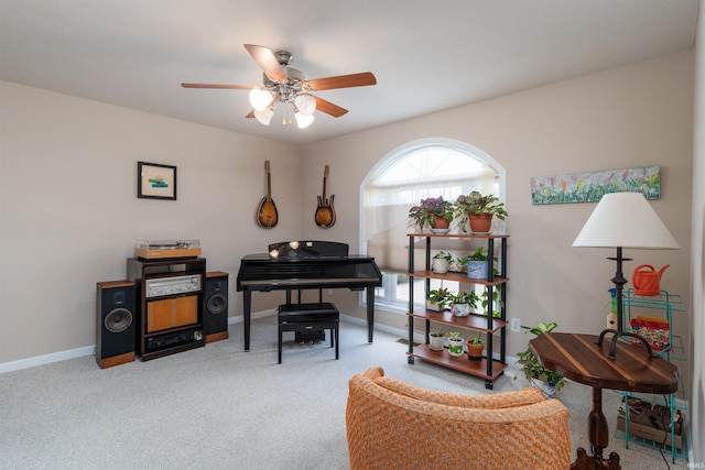 carpeted office featuring ceiling fan