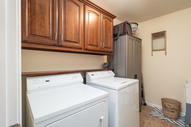 laundry room featuring cabinets, independent washer and dryer, and light tile patterned flooring