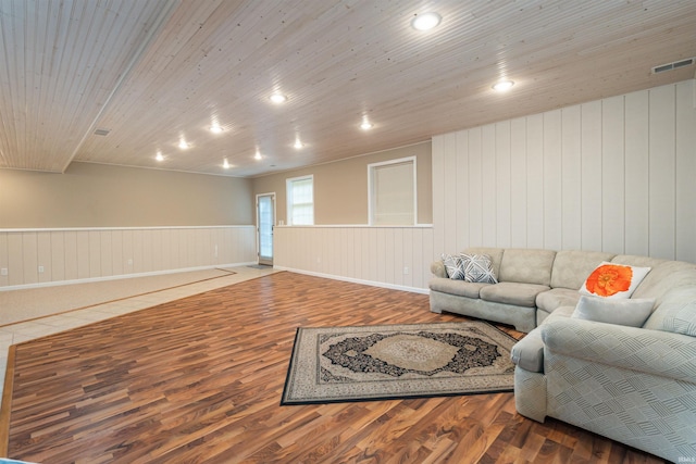 living room with wooden ceiling, hardwood / wood-style floors, and wood walls