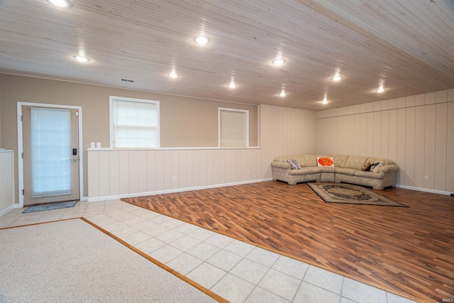 unfurnished living room featuring wood ceiling and light tile patterned floors