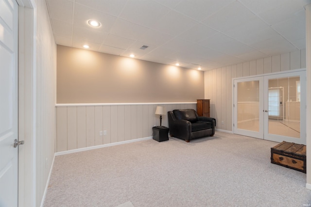 living area with french doors and carpet