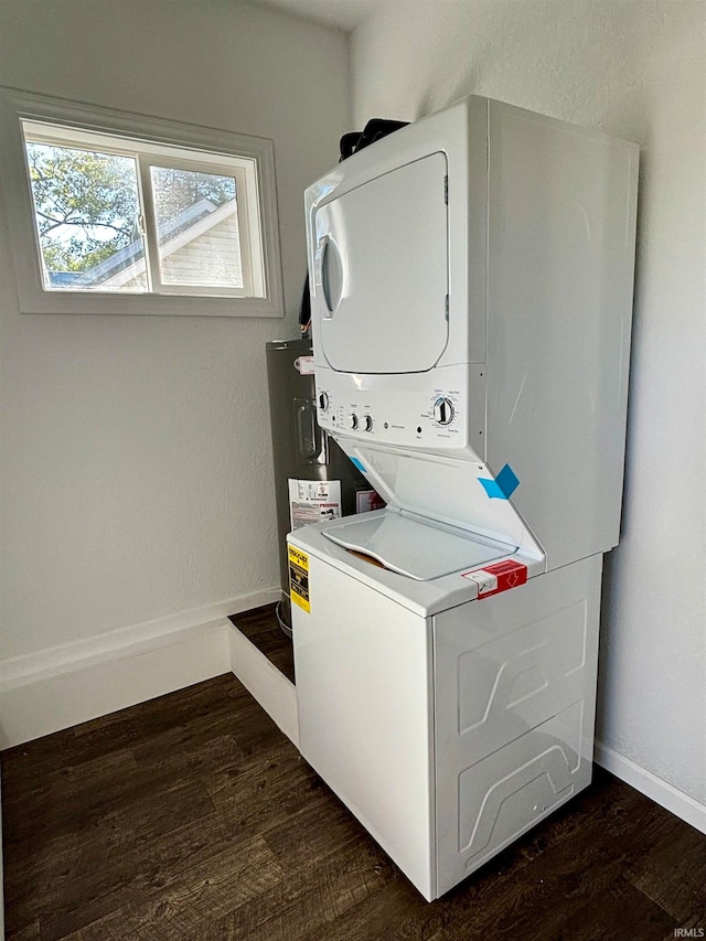 clothes washing area featuring dark wood-type flooring and stacked washer / dryer