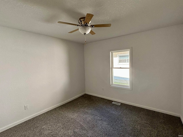 spare room with carpet flooring, ceiling fan, and a textured ceiling