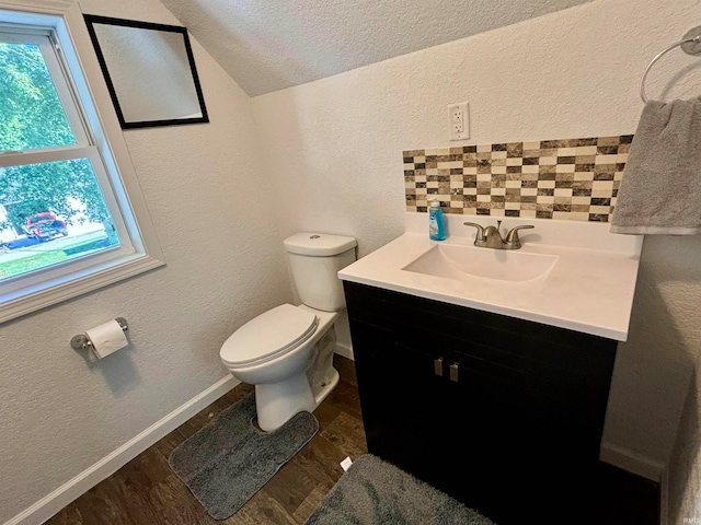 bathroom with a textured ceiling, vanity, toilet, and wood-type flooring