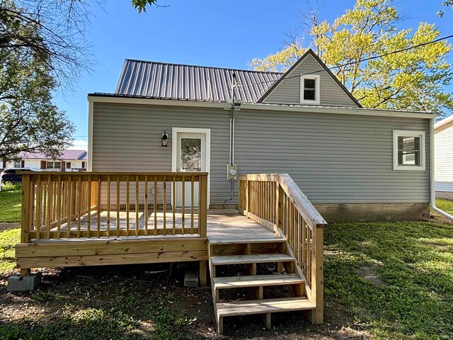 rear view of house featuring a wooden deck