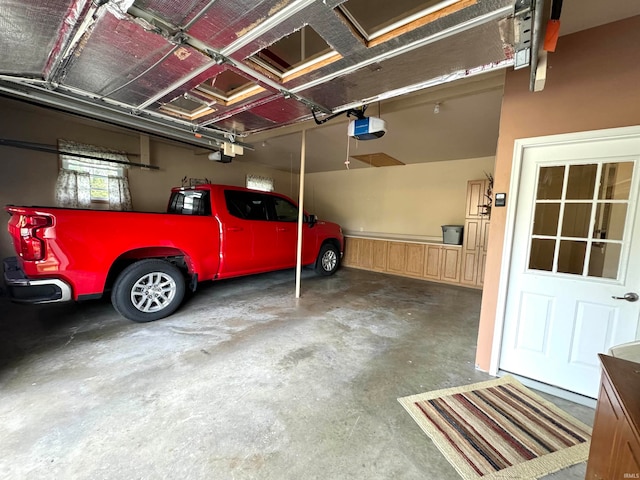 garage with a garage door opener and a carport