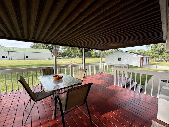 deck with a storage shed and a lawn