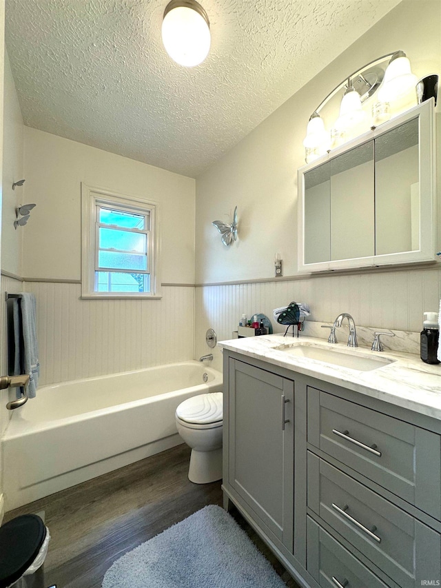 bathroom with hardwood / wood-style floors, toilet, a textured ceiling, and vanity