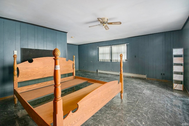 bedroom with a baseboard radiator, ceiling fan, and wooden walls