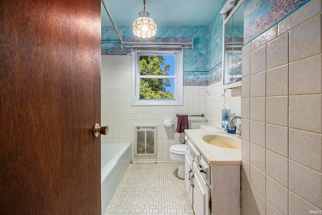 bathroom with tile walls, toilet, heating unit, and vanity