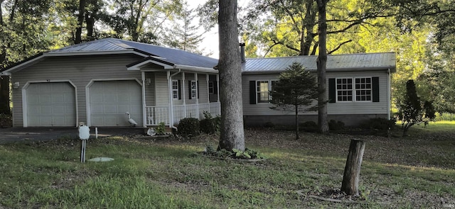 single story home with an attached garage and metal roof