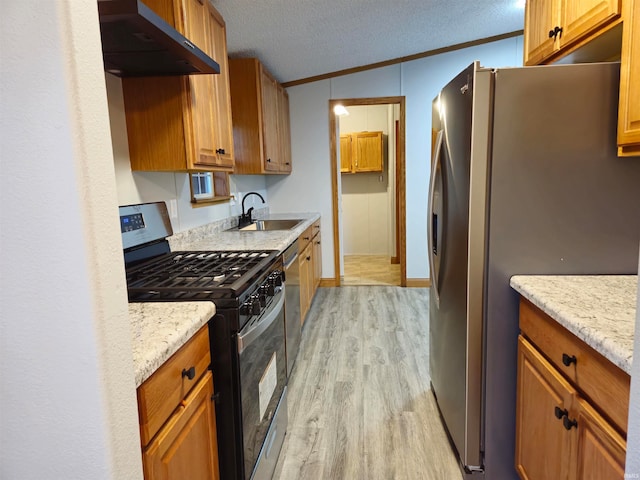 kitchen featuring a textured ceiling, light hardwood / wood-style flooring, stainless steel appliances, and sink