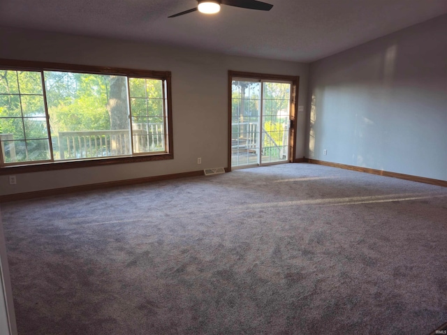 spare room with ceiling fan and carpet flooring