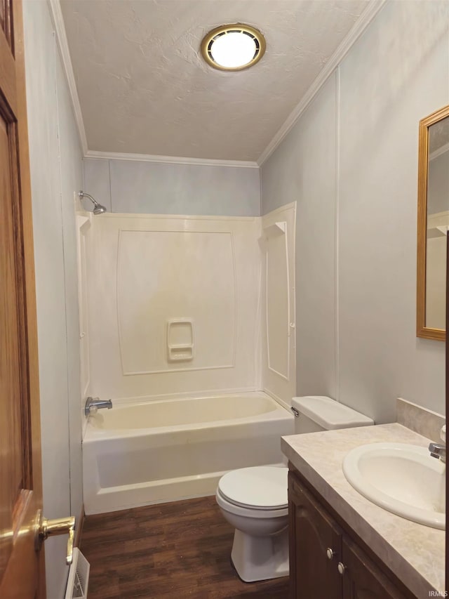 full bathroom featuring crown molding, hardwood / wood-style floors, toilet, tub / shower combination, and vanity