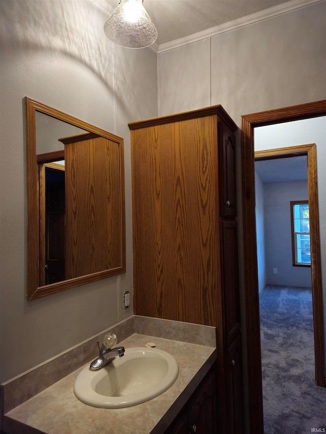 bathroom featuring ornamental molding and vanity