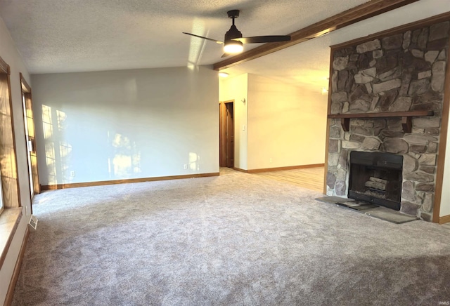 unfurnished living room with a textured ceiling, ceiling fan, vaulted ceiling, and a fireplace