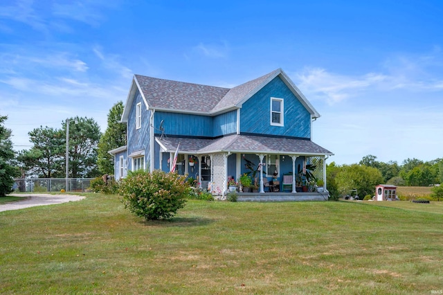 view of front facade featuring a front yard and covered porch