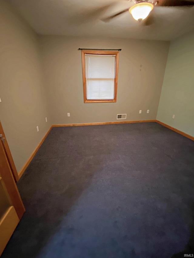 carpeted empty room featuring ceiling fan