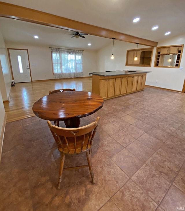 unfurnished dining area with beamed ceiling and ceiling fan