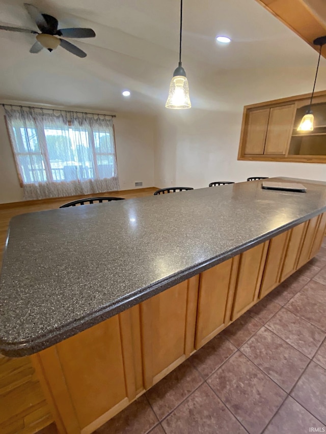 kitchen featuring pendant lighting, ceiling fan, and tile patterned floors