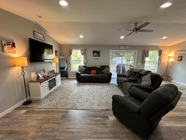 living room featuring lofted ceiling, ceiling fan, and hardwood / wood-style flooring