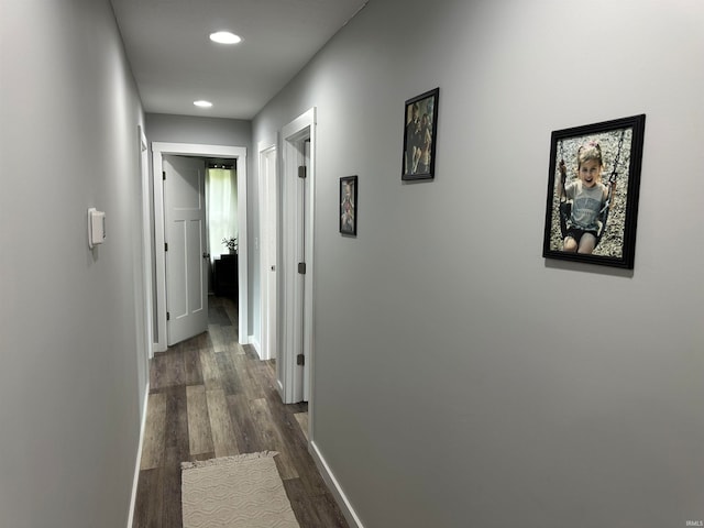 corridor with hardwood / wood-style flooring