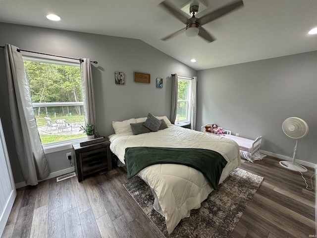 bedroom featuring ceiling fan, dark hardwood / wood-style flooring, and vaulted ceiling