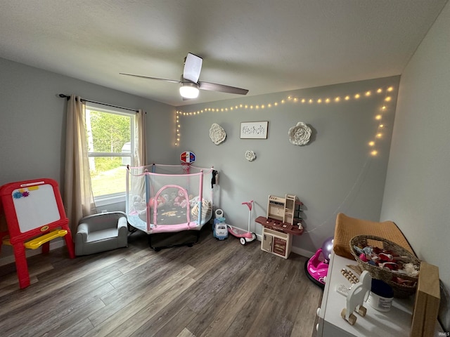 bedroom featuring a textured ceiling, ceiling fan, and wood-type flooring