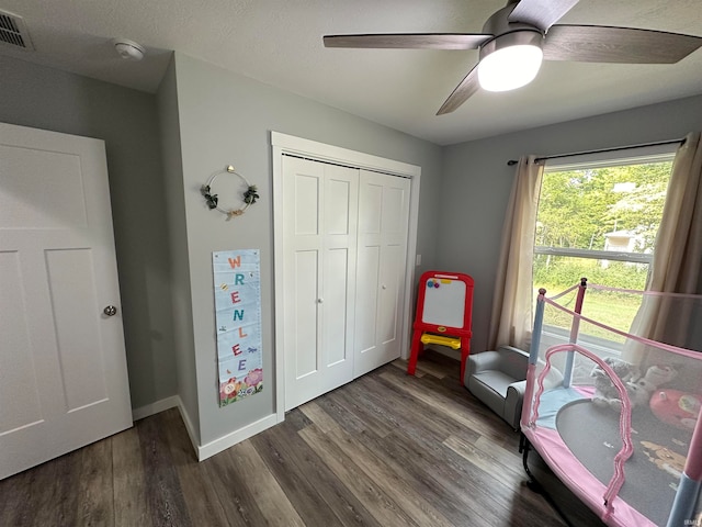 interior space with dark hardwood / wood-style flooring, ceiling fan, and a textured ceiling