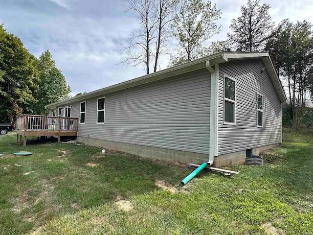 view of home's exterior featuring a lawn and a wooden deck