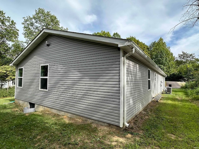 view of home's exterior with central AC unit and a lawn