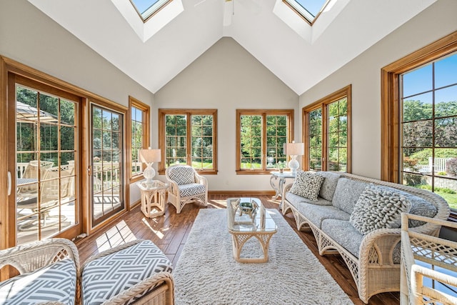 sunroom / solarium with vaulted ceiling with skylight and ceiling fan