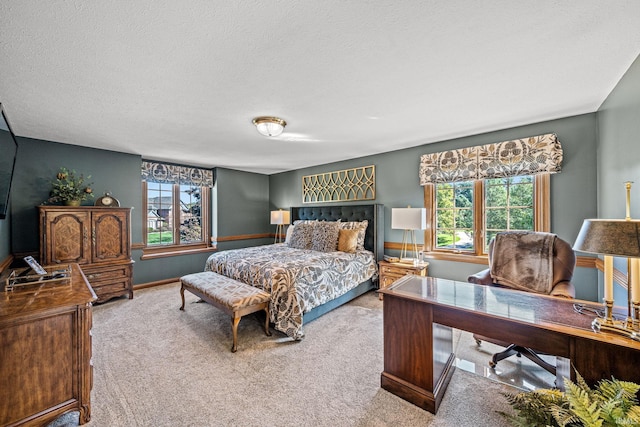 carpeted bedroom featuring multiple windows and a textured ceiling