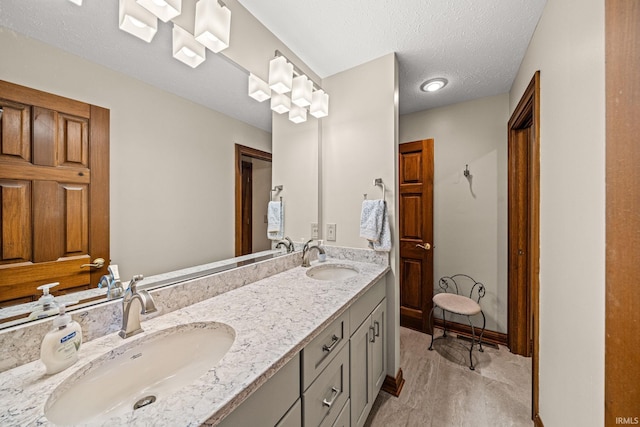 bathroom featuring vanity, a textured ceiling, and wood-type flooring