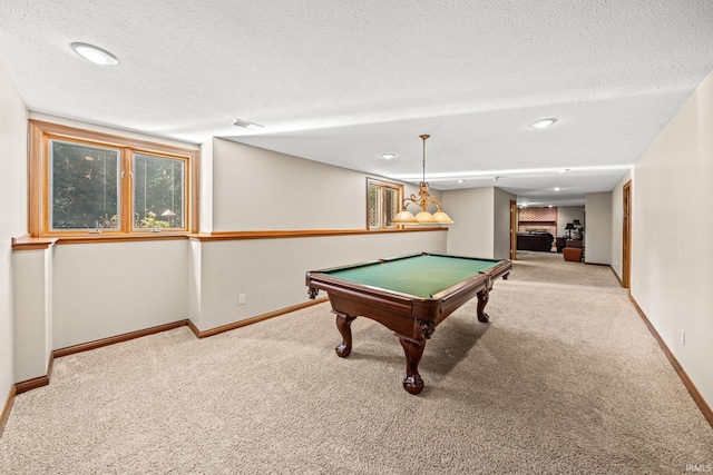 game room featuring billiards, light carpet, and a textured ceiling