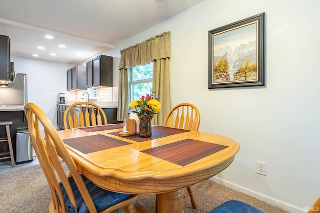 dining area with recessed lighting, light carpet, and baseboards