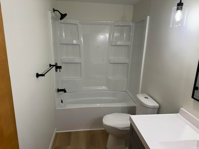 full bathroom with wood-type flooring, toilet,  shower combination, and vanity