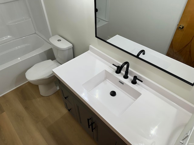 full bathroom featuring vanity, toilet, shower / bath combination, and wood-type flooring