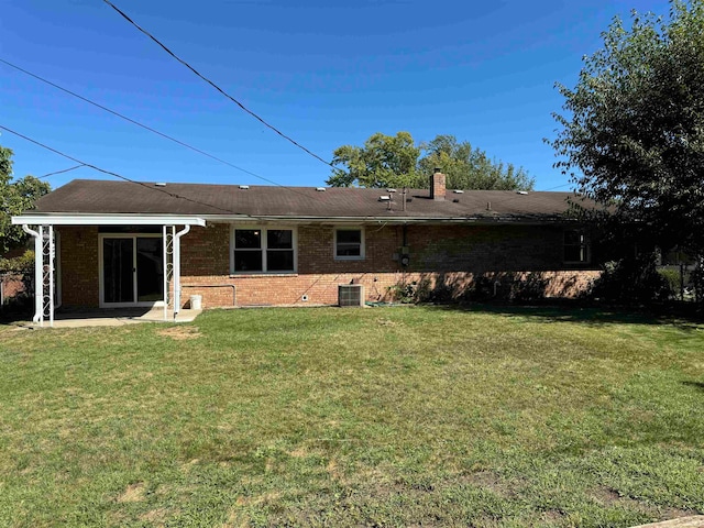 back of house featuring a patio area and a yard